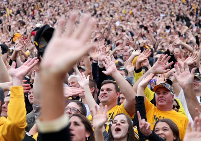Iowa fans do the "Iowa Wave" at Kinnick Stadium.