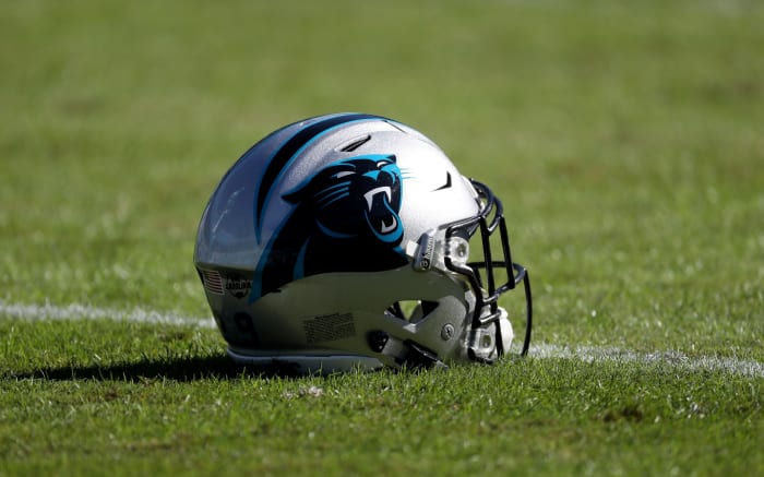 A picture of a Carolina Panthers helmet on the field.