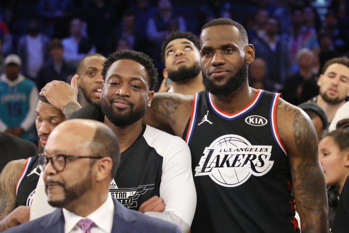 LeBron James putting his arm around Dywane Wade.