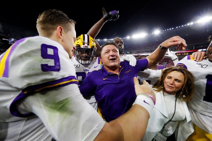 Joe Burrow and Ed Orgeron embrace.