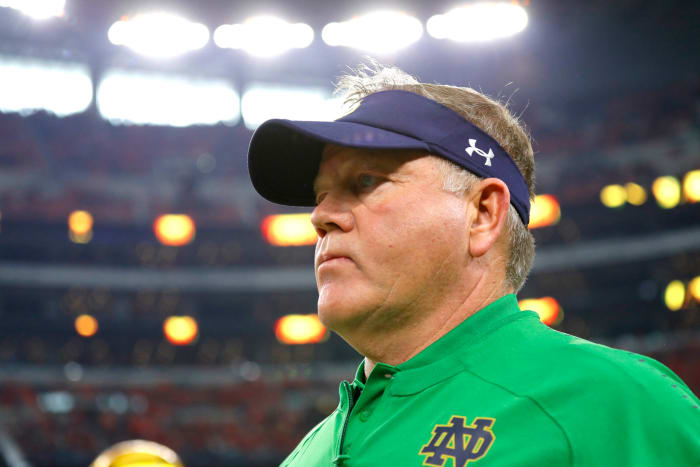 A closeup of Notre Dame head coach Brian Kelly wearing a visor.
