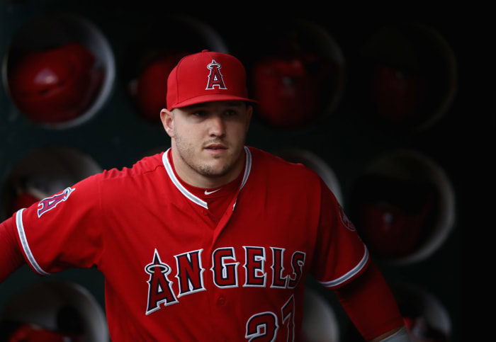 Mike Trout stands in the dugout.