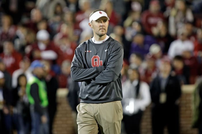 A closeup of Lincoln Riley wearing an Oklahoma Sooners sweater.