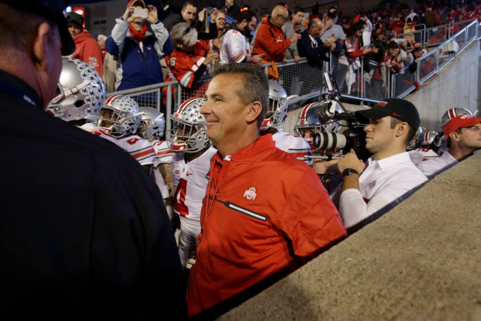 A closeup of Urban Meyer walking onto the field for an Ohio State football game.