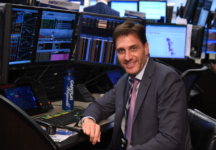 ESPN star and diehard New York Jets fan Mike Greenberg sitting at a computer.