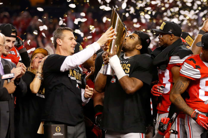 Ohio State football's Urban Meyer, Ezekiel Elliott, and the College Football Playoff trophy.