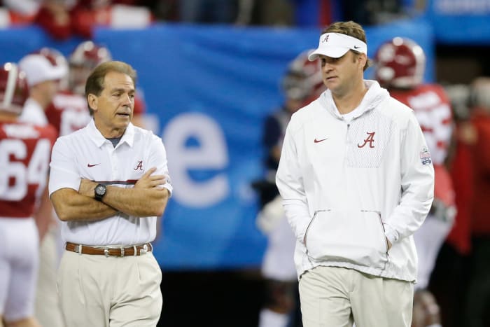 Nick Saban talking to Lane Kiffin before a game.