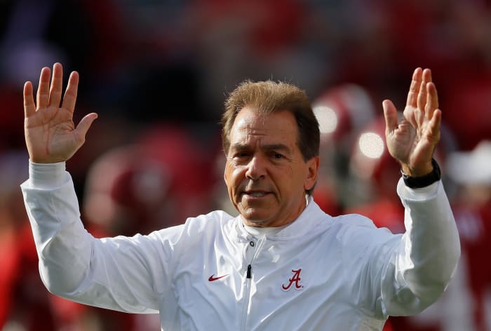 Alabama coach Nick Saban raising both of his arms.