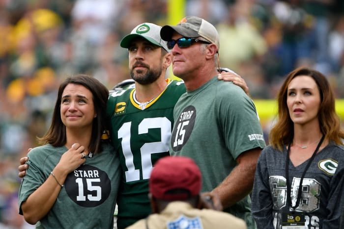 Brett Favre stands with Aaron Rodgers before a Packers game.