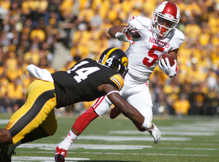 Wide receiver J-Shun Harris II #5 of the Indiana Hoosiers is tripped up by defensive back Desmond King #14 of the Iowa Hawkeyes.