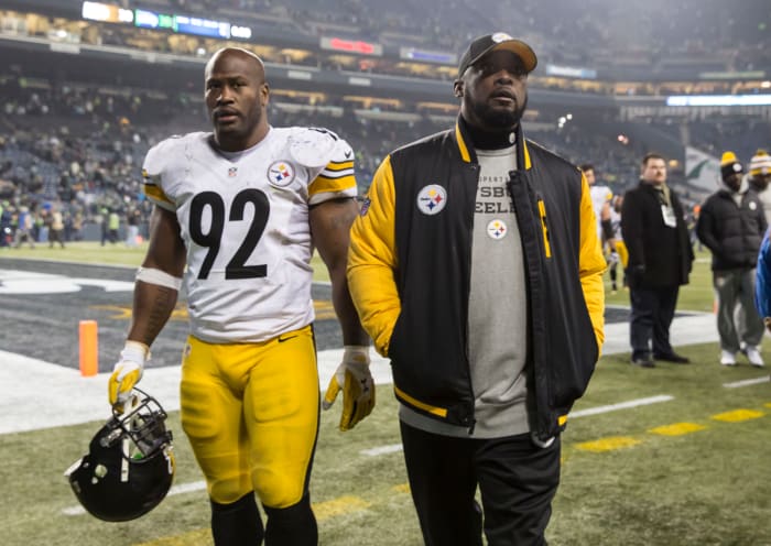 James Harrison and Mike Tomlin walk off the field.