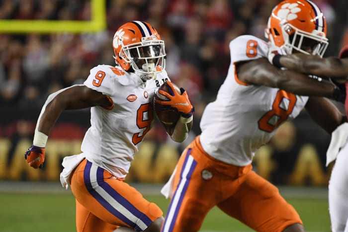 Travis Etienne carries the ball for Clemson football against Alabama in the national title game.