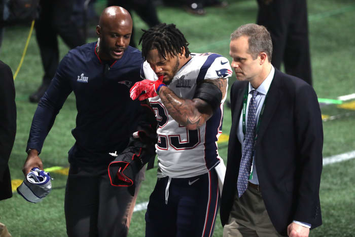 Patrick Chung of the Patriots walks off the field after injuring his arm in the Super Bowl.
