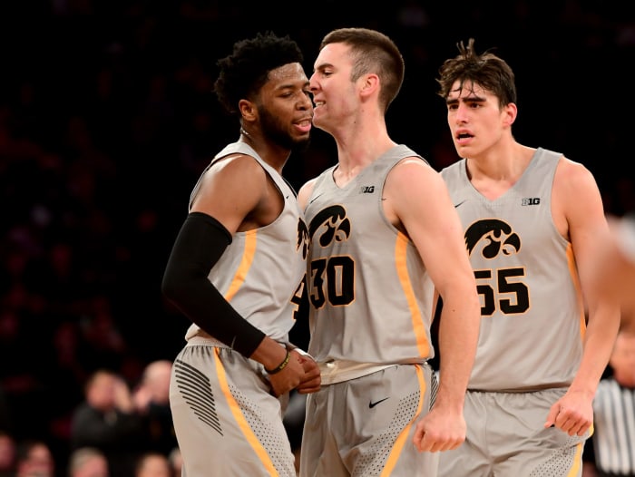 Connor McCaffery, Isaiah Moss and Luka Garza celebrate.