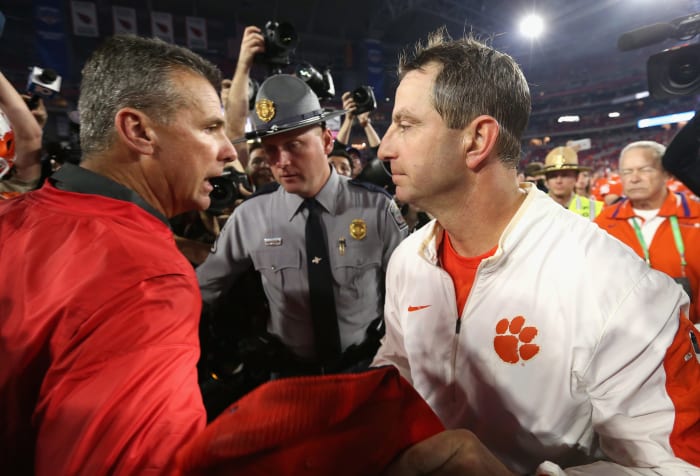 Dabo Swinney shakes Urban Meyer's hand.