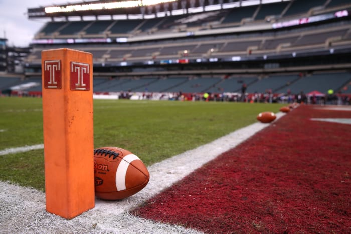 A football resting by the pylon at the Temple Owls game