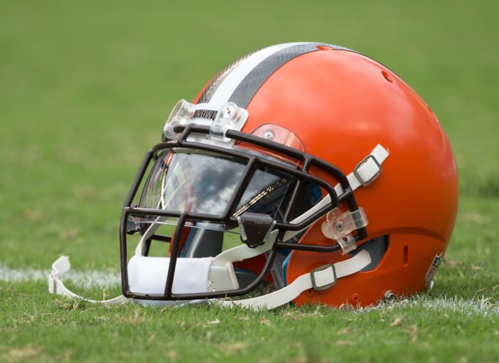 A Cleveland Browns helmet sitting on the field.