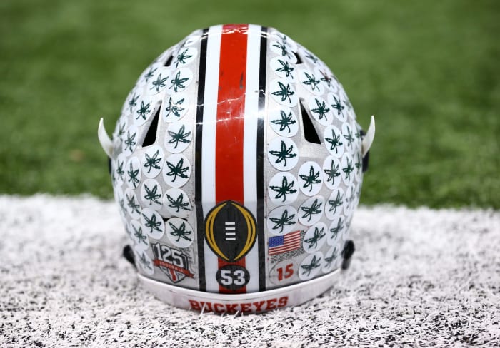 A closeup of an Ohio State football helmet on the field.