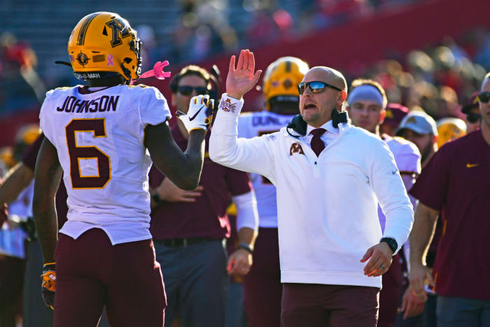 P.J. Fleck high-fives Tyler Johnson on the Minnesota sideline.