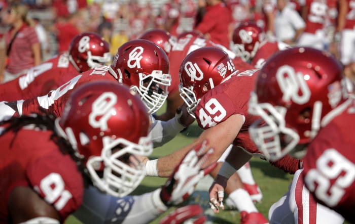 Oklahoma's linemen warming up before a football game against the West Virginia Mountaineers.