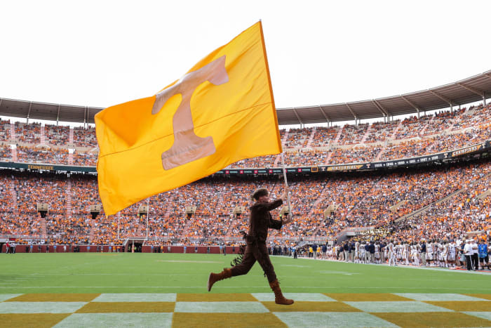 Tennessee's mascot running with a Tennessee flag.