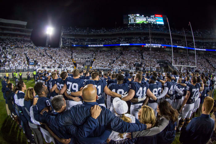 Penn State football players sing to celebrate win.