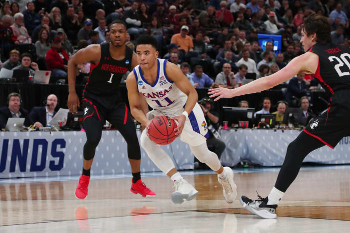 Devon Dotson of Kansas tries to score.