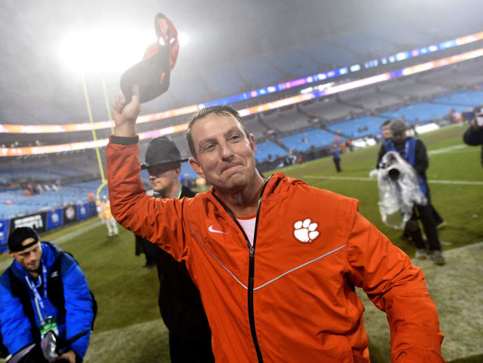Dabo Swinney greets a Clemson football fan in the crowd.