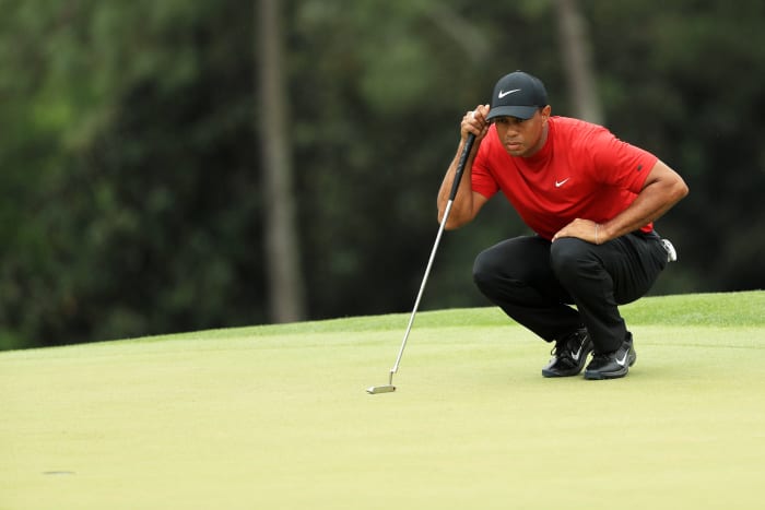 Tiger Woods reading the green.