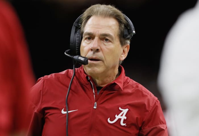 A closeup of Nick Saban wearing a headset during an Alabama football game.