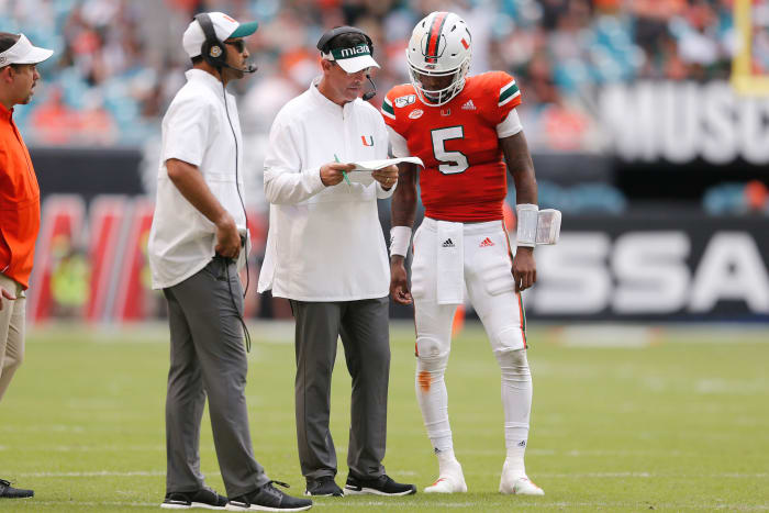 Miami coach Dan Enos speaks with N'Kosi Perry.