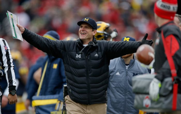 Head coach Jim Harbaugh of the Michigan Wolverines reacts to a roughing the kicker call against his team during the first quarter against the Ohio State Buckeyes.
