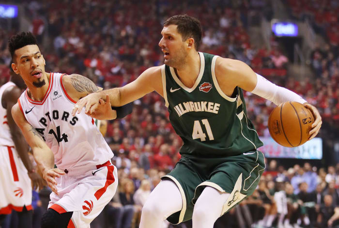 Nikola Mirotic dribbles against Danny Green during Milwaukee Bucks vs. Toronto Raptors.