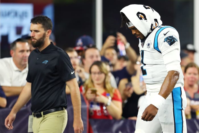 Cam Newton walks off the field.