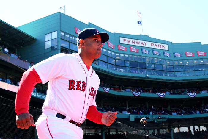 Alex Cora running onto the field.