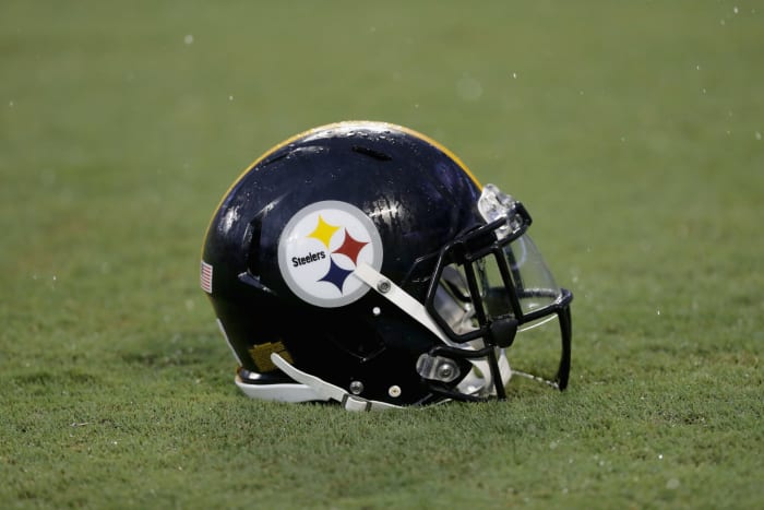 A Pittsburgh Steelers helmet sitting on the field.