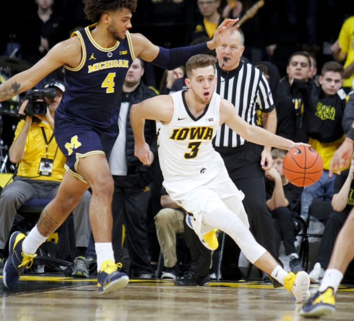 Iowa's Jordan Bohannon dribbles past Michigan's Isaiah Livers.