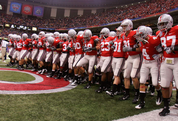 Ohio State football players locking arms before a game.