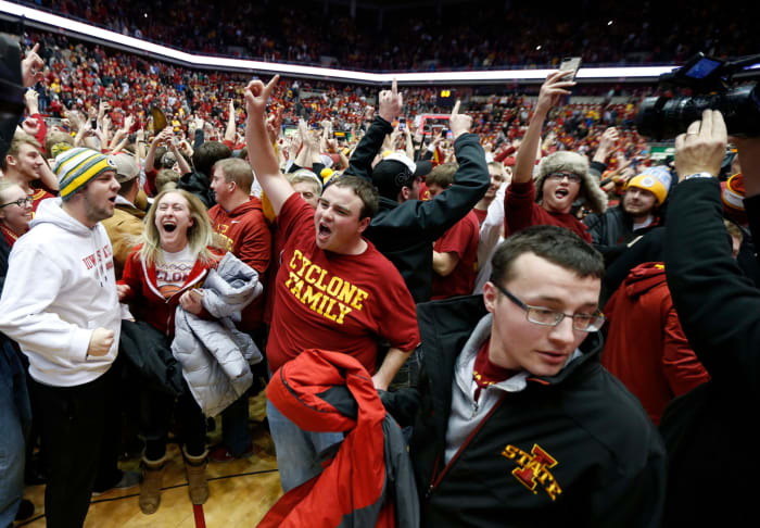The Iowa State Cyclones fans storm the court after Iowa State defeated the Oklahoma Sooners 82-77 at Hilton Coliseum.