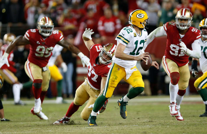 Aaron Rodgers rolls out for a pass against the 49ers.