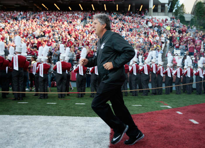 Mike Leach runs onto the field.