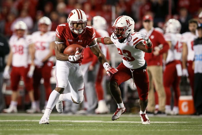 Wisconsin receiver evades Nebraska defender.