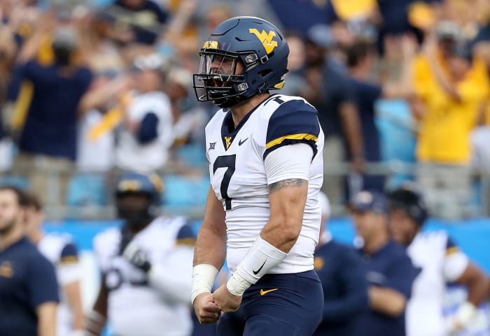 Will Grier celebrating a touchdown throw.