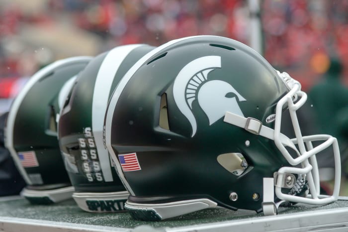 A closeup of three Michigan State football helmets before a game.