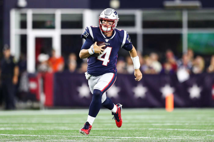 Jarrett Stidham of the New England Patriots runs with the ball.