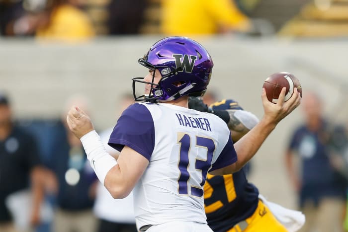 Jake Haener of the Washington Huskies throw a pass.