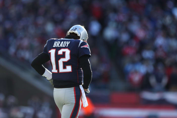 New England Patriots QB Tom Brady taking the field during a game.
