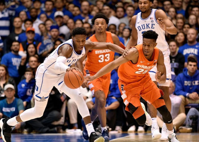 Tyus Battle and RJ Barrett fight for the ball.