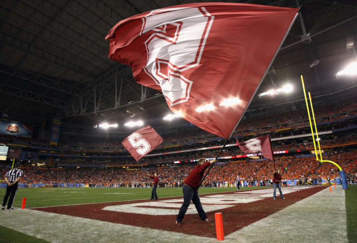 A Stanford cheerleader waving a flag.