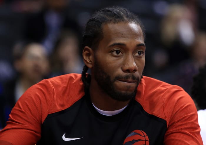 An extreme closeup of Kawhi Leonard sitting on the bench.